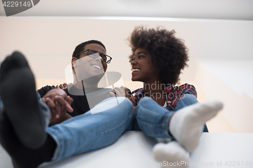 Image of couple having break during moving to new house