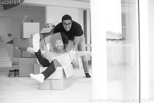 Image of African American couple  playing with packing material