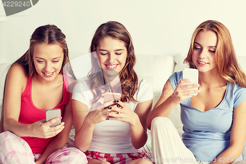 Image of friends or teen girls with smartphone at home