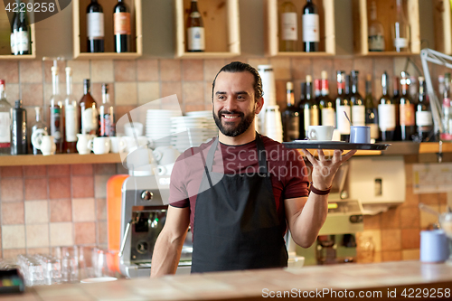Image of happy man or waiter with coffee and sugar at bar