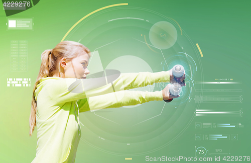 Image of sporty woman with dumbbells flexing biceps