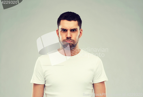 Image of man with funny angry face over gray background