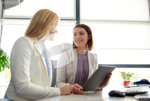 Image of businesswomen with tablet pc computer at office