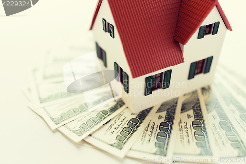 Image of close up of home or house model and money