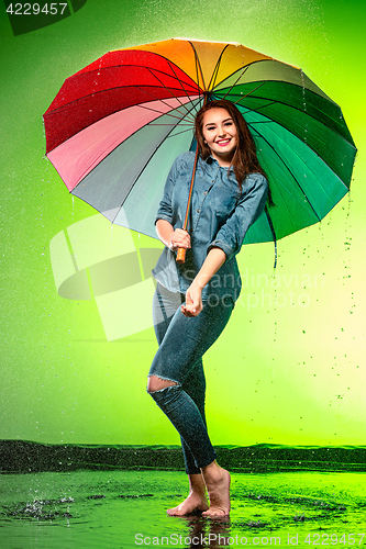Image of Young beautiful woman with an umbrella.