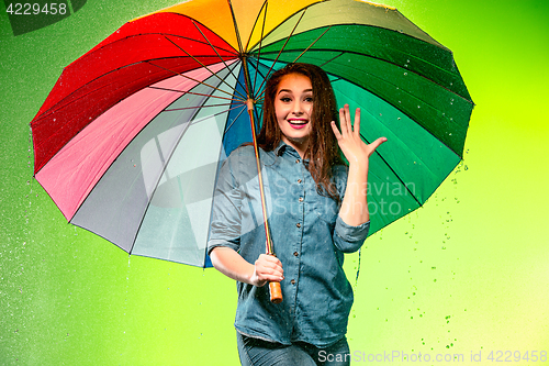 Image of Young beautiful woman with an umbrella.