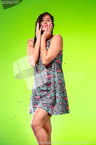 Image of Young beautiful woman under splash of rain