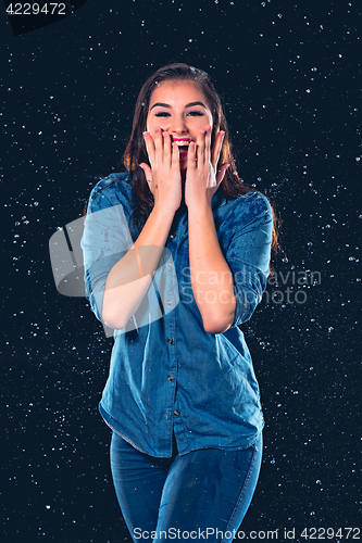 Image of Young beautiful woman under splash of rain