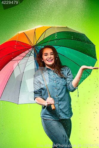 Image of Young beautiful woman with an umbrella.