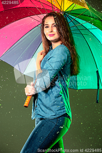 Image of Young beautiful woman with an umbrella.