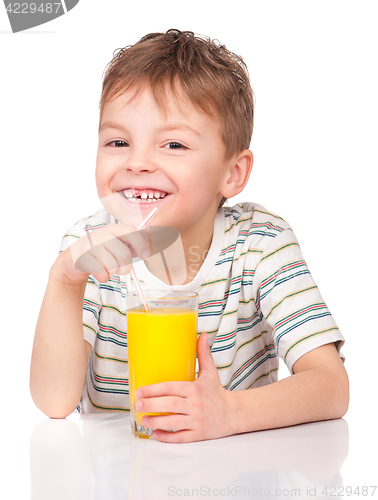 Image of Little boy drinking orange juice