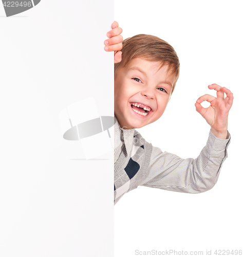 Image of Little boy peeking from blank board