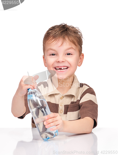 Image of Little boy with plastic bottle of water