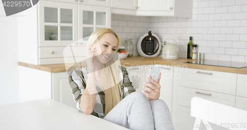 Image of Charming female taking selfie in kitchen