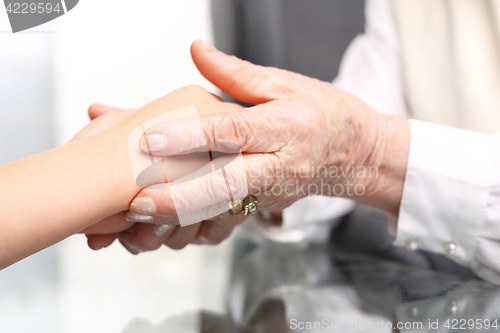 Image of Helping hand. The hand old woman hugs a child&#39;s hand