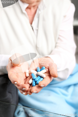 Image of Health retired. An elderly woman holding a tablet in her hands.