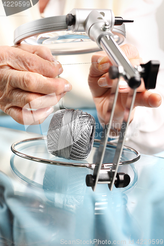 Image of Threading the needle under the magnifying glass Grandma&#39;s hobby, embroidering  Grandma threaded needle embroidery