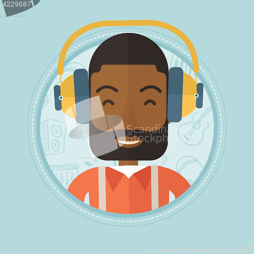 Image of Man listening to music in headphones.