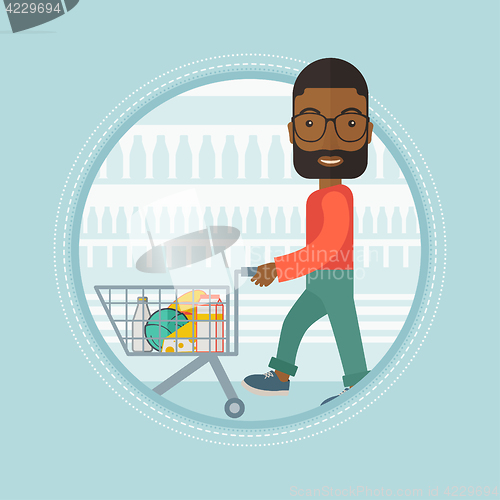 Image of Customer walking in store with shopping trolley.