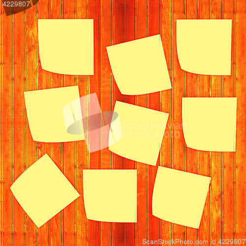 Image of Mock-up of Sticky note paper on a wooden wall. 3D illustration. 