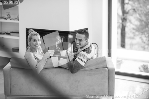 Image of Young couple  in front of fireplace