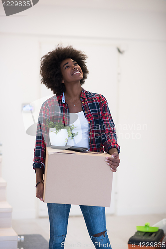 Image of Black girl moving in the new apartment