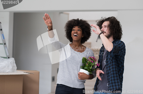 Image of multiethnic couple moving into a new home