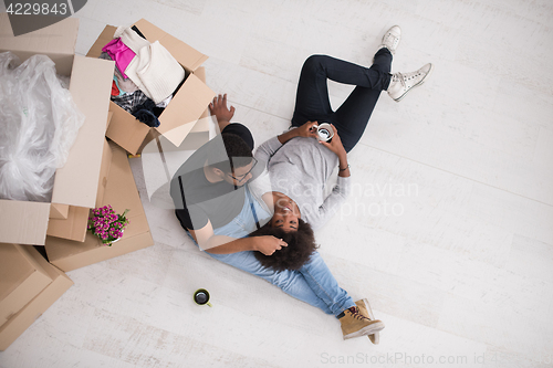 Image of African American couple relaxing in new house