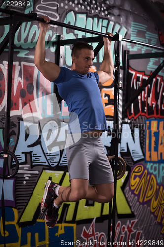 Image of man doing pull ups