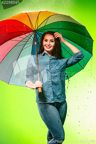 Image of Young beautiful woman with an umbrella.