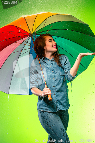 Image of Young beautiful woman with an umbrella.