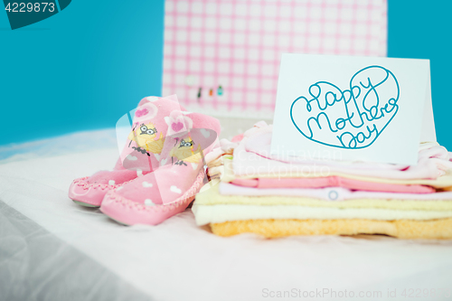 Image of The baby clothes with a gift box