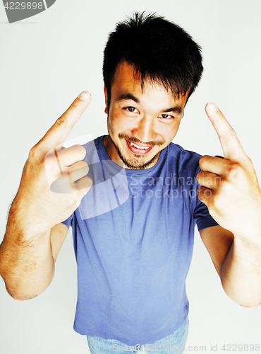 Image of young cute asian man on white background gesturing emotional, po
