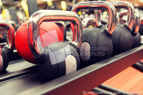 Image of close up of kettlebells and medicine ball in gym