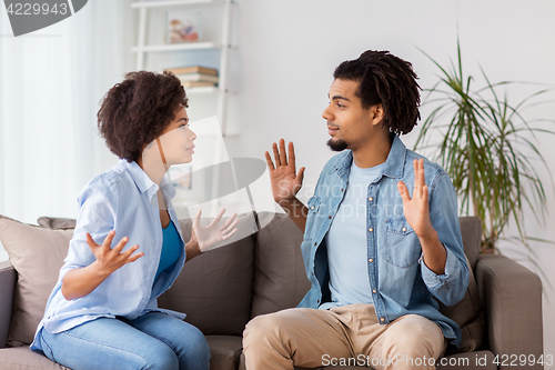 Image of unhappy couple having argument at home