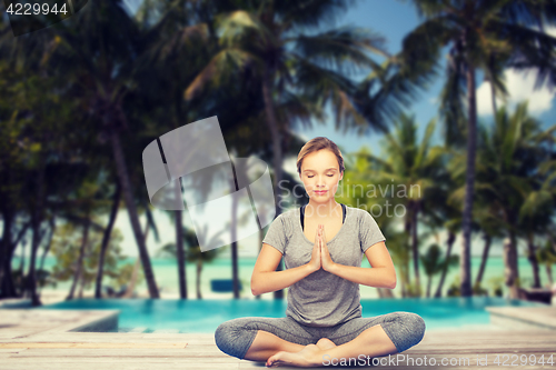 Image of woman making yoga meditation in lotus pose