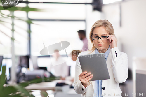 Image of businesswoman with tablet pc at office