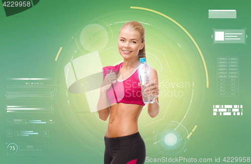 Image of sporty woman with bottle of water and towel
