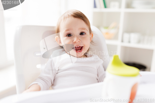 Image of happy smiling baby sitting in highchair at home