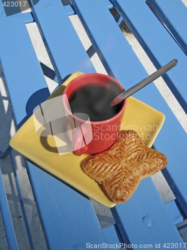 Image of steaming coffee cup on a chair