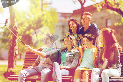 Image of happy teenage students taking selfie by smartphone