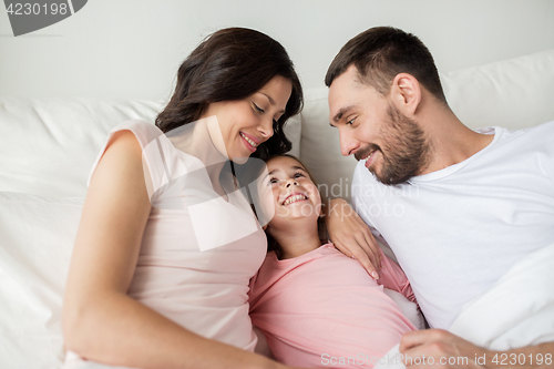 Image of happy family in bed at home