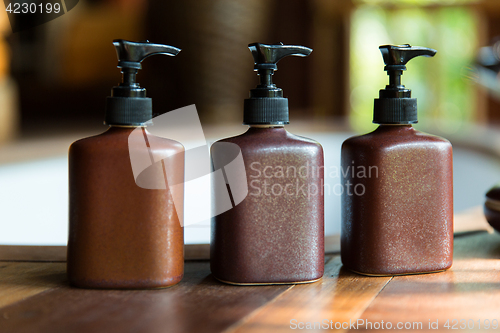 Image of bottles with liquid soap or lotion at bathroom