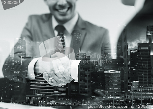 Image of two businessmen shaking hands at office