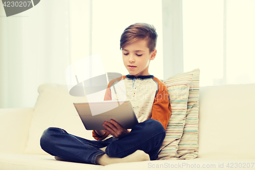 Image of boy with tablet computer at home