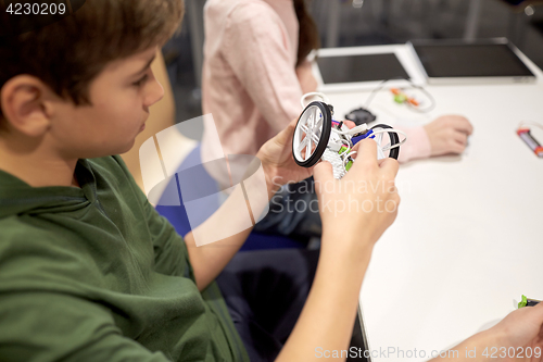 Image of boy building robot at robotics school