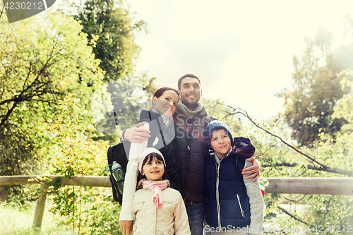 Image of happy family with backpacks hiking