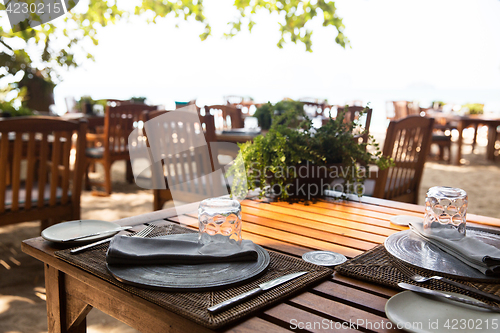 Image of served table at open-air restaurant on beach