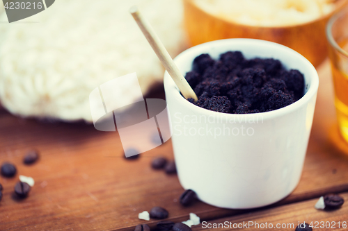 Image of close up of coffee scrub in cup on wooden table