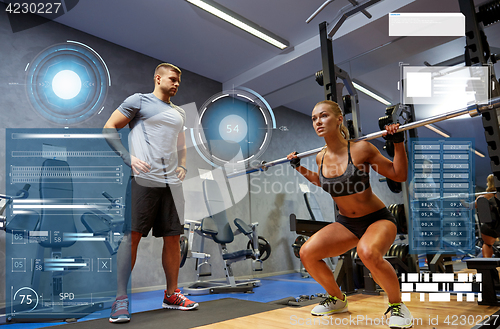 Image of man and woman with bar flexing muscles in gym